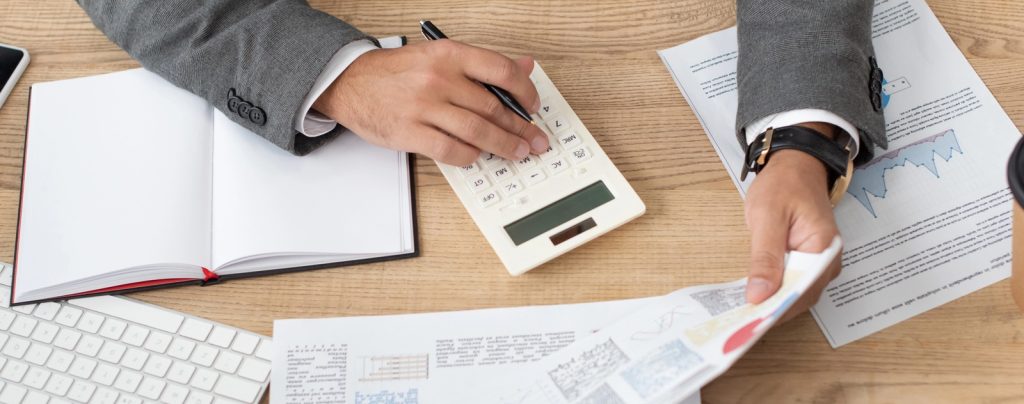 Photo of a man with financials on his desk